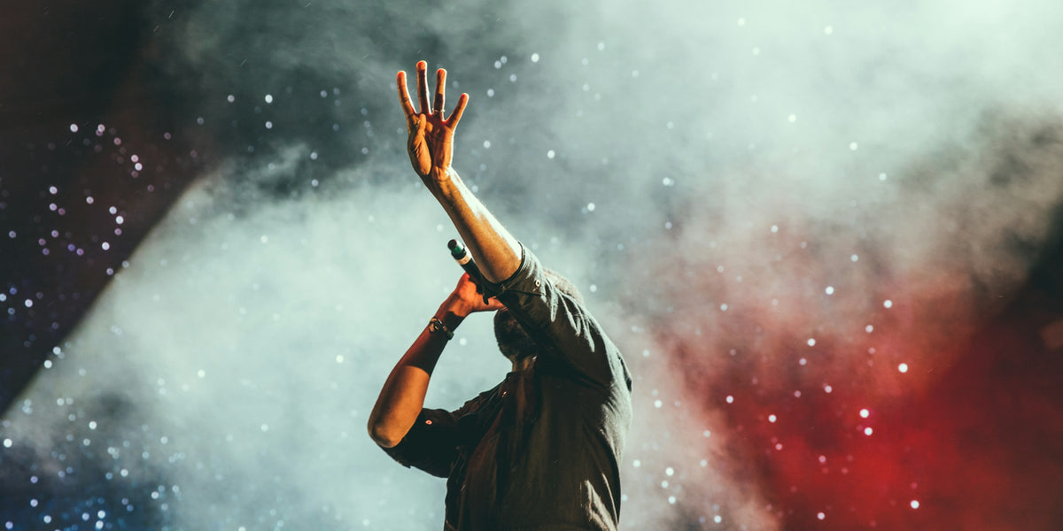 Person raising their hands at a live concert